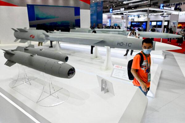 A man walks among supersonic cruise missiles at the 13th China International Aviation and Aerospace Exhibition in Zhuhai, in southern China's Guangdong Province, on Sept. 28, 2021. (Noel Celis/AFP via Getty Images)