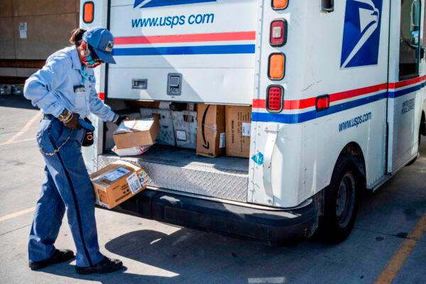 U.S. Postal Service mail carrier Lizette Portugal finishes loading her truck in El Paso, Texas, on April 30, 2020. (Paul Ratje/AFP via Getty Images)