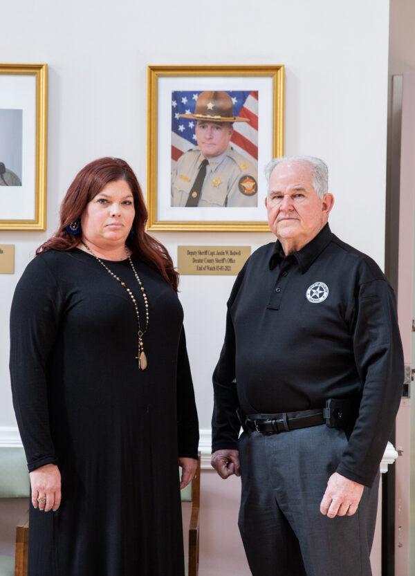 Katherine Bedwell and Sherrif Wiley Griffin in front of photo of Capt. Justin Bedwell at the Decatur Co. Sherrif station in Bainbridge, Ga., on Nov. 10, 2021. (Amanda Greene for The Epoch Times)