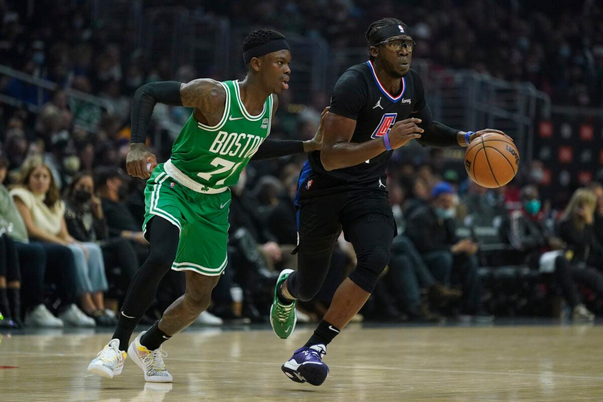 Boston Celtics guard Dennis Schroder (71) defends against Los Angeles Clippers guard Reggie Jackson (1) during the first half of an NBA basketball game in Los Angeles, on Dec. 8, 2021. (Ashley Landis/AP Photo)
