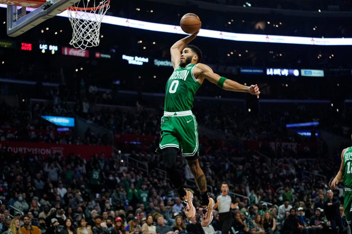 Boston Celtics forward Jayson Tatum (0) dunks the ball during the second half of an NBA basketball game against the Los Angeles Clippers in Los Angeles, on Dec. 8, 2021. (Ashley Landis/AP Photo)