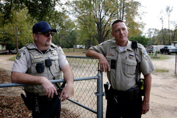 Webster Parish Sgt. Coby Barton (L) and Webster Parish Sheriff Lt. Chuck Clark in Doyline, La., at the scene where Officer William "Billy" Collins was shot July 9, 2021, in Doyline, La., on Nov. 17, 2021. (Bobby Sanchez for The Epoch Times)
