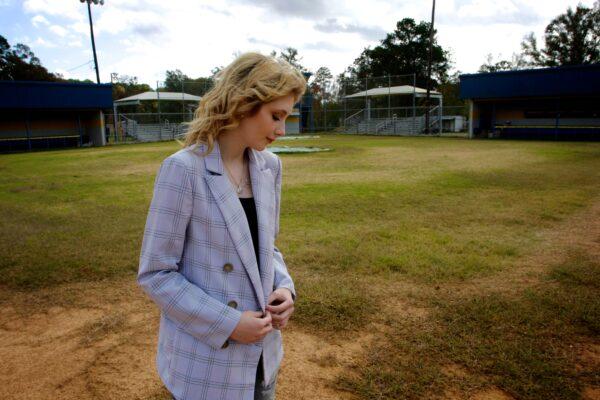 Danielle Collins, daughter of slain police officer William "Billy" Collins, stands at second base on the baseball diamond from which her father was airlifted, in Doyline, La., on Nov. 17, 2021. (Bobby Sanchez for The Epoch Times)