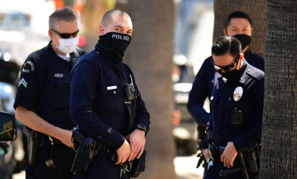 Los Angeles Police Department officers wear facial covering while monitoring an "Open California" rally in downtown Los Angeles, on April 22, 2020. (Frederic J. Brown/AFP via Getty Images)