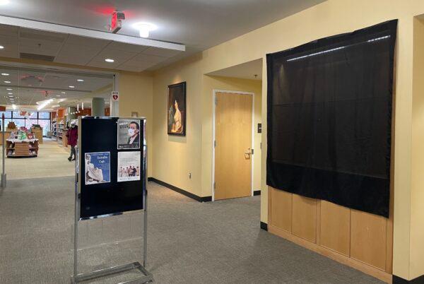 The glass display case in the lobby that featured LGBTQ books and the Bible was covered by a black curtain at Dolley Madison Library in McLean, Va., on Dec. 8, 2021. (Terri Wu/The Epoch Times)