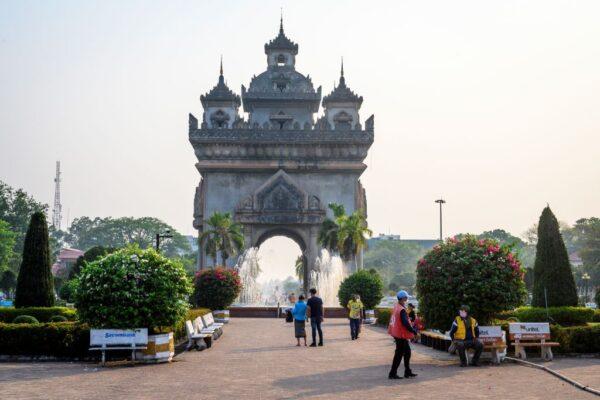 People walking in front of the Patuxai war monument in the centre of Vientiane, Laos, on March 12, 2020. (Mladen Antonov/AFP via Getty Images)