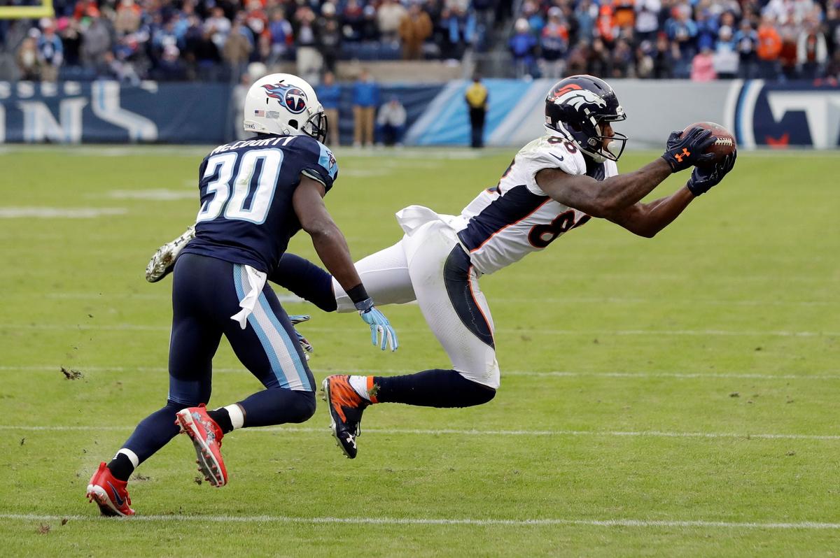 Denver Broncos wide receiver Demaryius Thomas (88) catches a pass as he is defended by Tennessee Titans cornerback Jason McCourty (30) during the second half of an NFL football game in Nashville, Tenn., on Dec. 11, 2016. (James Kenney/AP Photo)