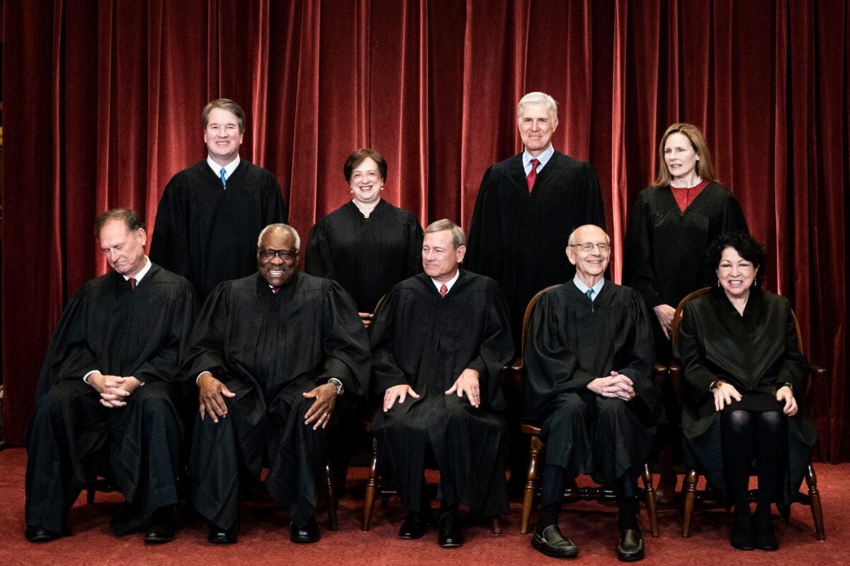 Members of the Supreme Court pose for a group photo at the Supreme Court in Washington on April 23, 2021. (Erin Schaff/Pool/Getty Images)