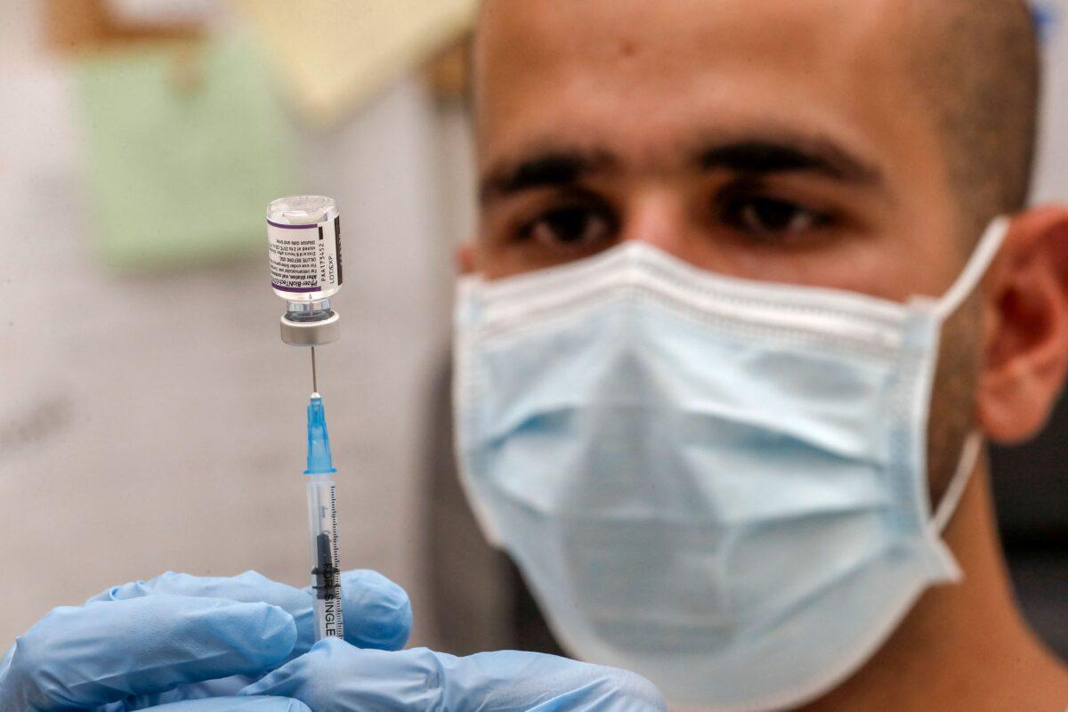 A health care worker in Israel prepares a dose of the Pfizer-BioNTech vaccine in a file photo. (Ahmad Ghababli/AFP via Getty Images)