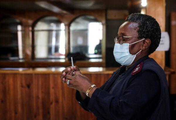 A healthcare worker prepares a dose of Pfizer’s COVID-19 vaccine in Johannesburg, South Africa, on Dec. 9, 2021. (Sumaya Hisham/Reuters)