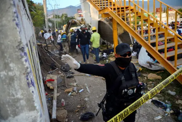 Emergency crew assists an injured person after a trailer crash in the southern Mexican state of Chiapas killed 55 people, most of them from Central America, officials said in Tuxtla Gutierrez, Chiapas, Mexico, on Dec. 9, 2021. (El La Mira/via Reuters)