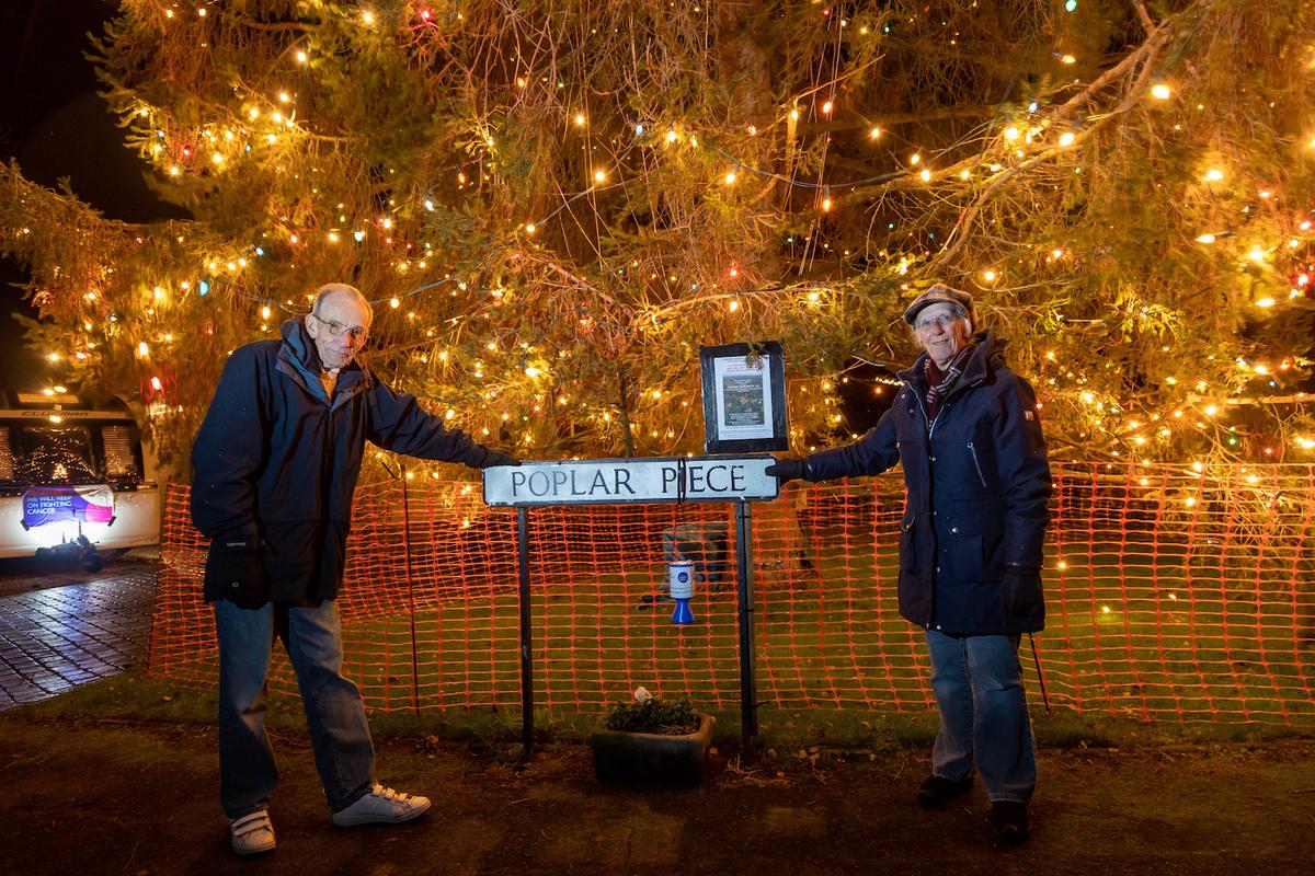 Avril and Christopher Rowlands switch on their Christmas tree lights in their garden in Inkberrow, Worcestershire. (SWNS)