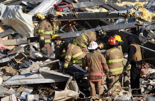 Emergency workers search through what is left of the Mayfield Consumer Products Candle Factory after it was destroyed by a tornado in Mayfield, Ky., on Dec. 11, 2021. (John Amis/AFP via Getty Images)