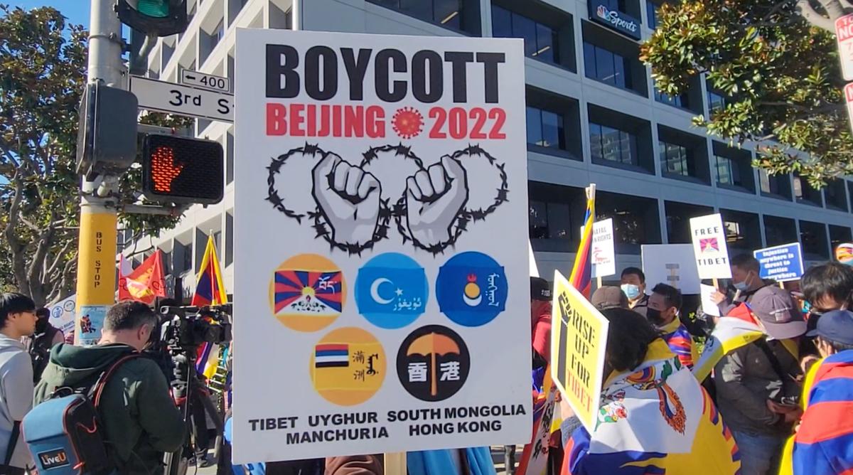 People holding signs urging for a boycott of the 2022 Beijing Winter Olympics in San Francisco, Calif. on Dec. 10, 2021 (Jason Blair/NTD Television)