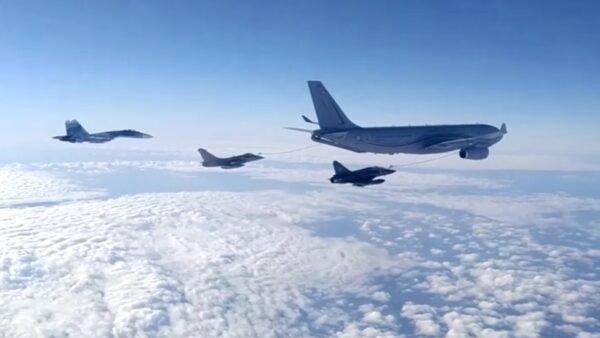 Three Russian fighter jets escort a NATO military aircraft over the Black Sea on Dec. 9, 2021. (Courtesy of Russian Defense Ministry)