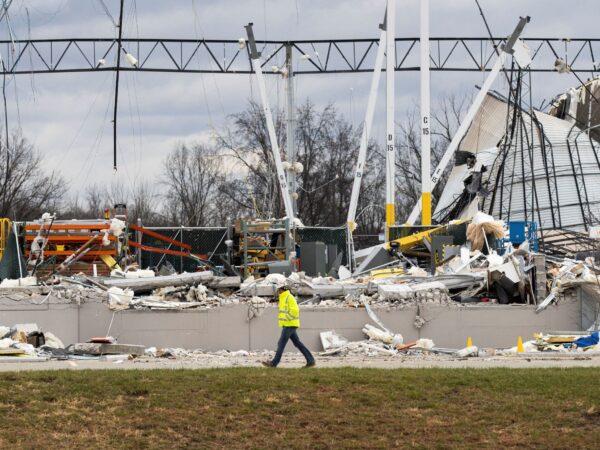 A responder walks past the wreckage at the site of a roof collapse at an Amazon distribution center after a tornado hits Edwardsville, in Ill., on Dec. 11, 2021. (Lawrence Bryant/Reuters)