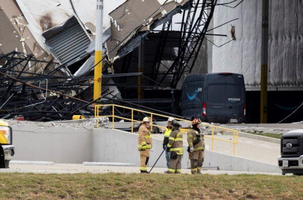 Responders stand at the site of a roof collapse at an Amazon distribution center after a tornado hits Edwardsville, in Ill., on Dec. 11, 2021. (Lawrence Bryant/Reuters)