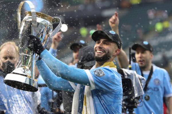 New York City FC forward Valentin Castellanos (11) celebrates with the trophy after their penalty kick shootout win over the Portland Timbers in the MLS Cup soccer game, in Portland, Ore., on Dec. 11, 2021. (Amanda Loman/AP Photo)