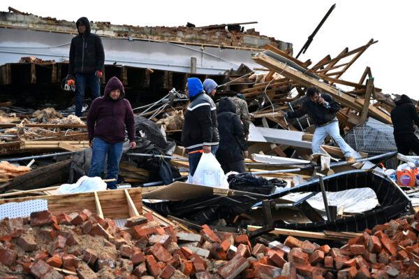 A family digs through the remains of their apartment in Mayfield, Ky., on Dec. 11, 2021. (Timothy D. Easley/AP Photo)