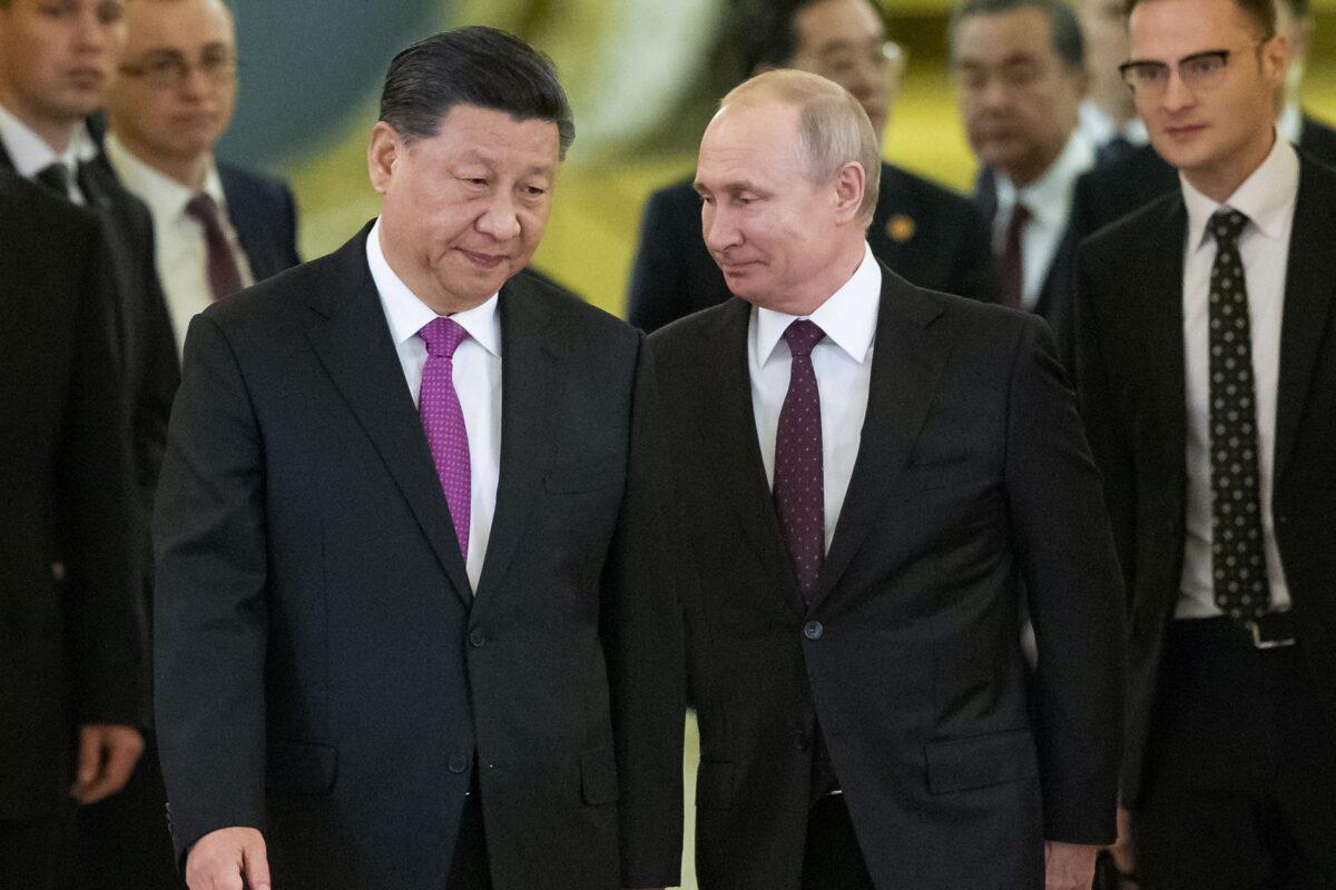 Chinese leader Xi Jinping and Russian President Vladimir Putin walk toward a hall in the Kremlin to hold talks, in Moscow on June 5, 2019. (Alexander Zemlianichenko/Pool/AP Photo)