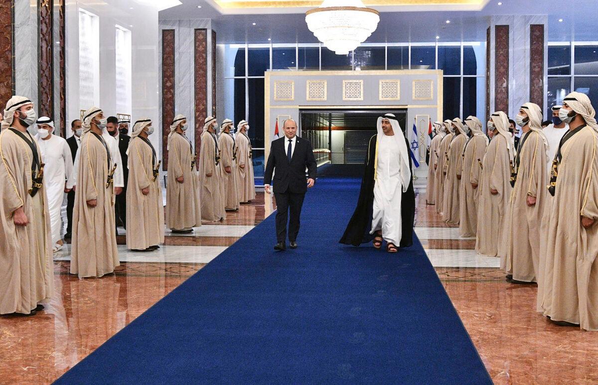 Israeli Prime Minister Naftali Bennett, left, received by an honor guard and the UAE Foreign Minister, Sheikh Abdullah bin Zayed Al Nahyan, in Abu Dhabi, on Dec. 12, 2021. (Haim Zach/Israel Government Press Office via AP)