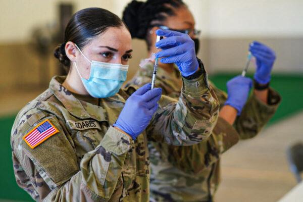 Spc. Kailee Soares prepares a dose of the COVID-19 vaccine during a drive to vaccinate Hawaii National Guardsmen assigned to the COVID-19 task force response on Kauai Island, Jan. 12, 2021. (U.S. Air National Guard/Master Sgt. Andrew Jackson)
