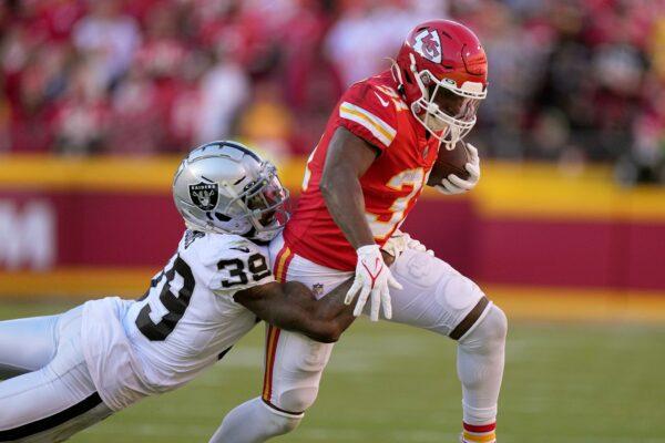 Kansas City Chiefs running back Darrel Williams (31) runs with the ball as Las Vegas Raiders cornerback Nate Hobbs (39) defends during the second half of an NFL football game in Kansas City, Mo., on Dec. 12, 2021. (Charlie Riedel/AP Photo)