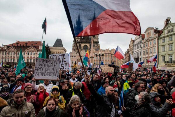 People wave the Czech national flag as they take part in a protest against COVID-19 measures earlier this year in Prague on Jan. 10, 2021. (Michal Cizek/AFP via Getty Images)