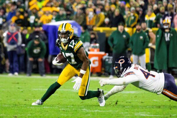 Green Bay Packers wide receiver Davante Adams runs after catching a pass while being defended by Chicago Bears linebacker Alec Ogeltree (44) during an NFL football game in Green Bay, Wis., on Dec. 12, 2021. (Adam Niemi/The Daily Mining Gazette via AP)