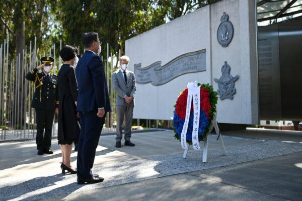 South Korean President Moon Jae-in and First Lady Kim Jung-sook pause after laying a wreath at the Australian National Korean War Memorial on December 13, 2021 in Canberra, Australia. (Lukas Coch - Pool/Getty Images)