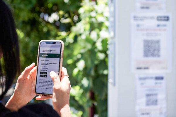 A user registers their SafeWA app before entry to a hotel in Perth, Australia, on Dec. 5, 2020. (Stefan Gosatti/Getty Images)