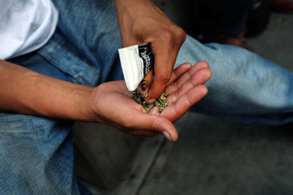 A man prepares to smoke Spice, a synthetic marijuana drug, along a New York City street on Aug. 5, 2015. (Spencer Platt/Getty Images)