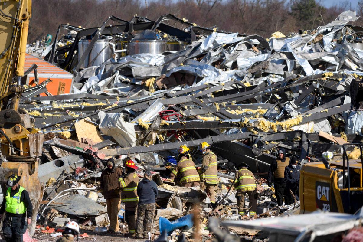Emergency workers search through what is left of the Mayfield Consumer Producers candle factory, in Mayfield, Ky., on Dec. 11, 2021. (John Amis/AFP via Getty Images)