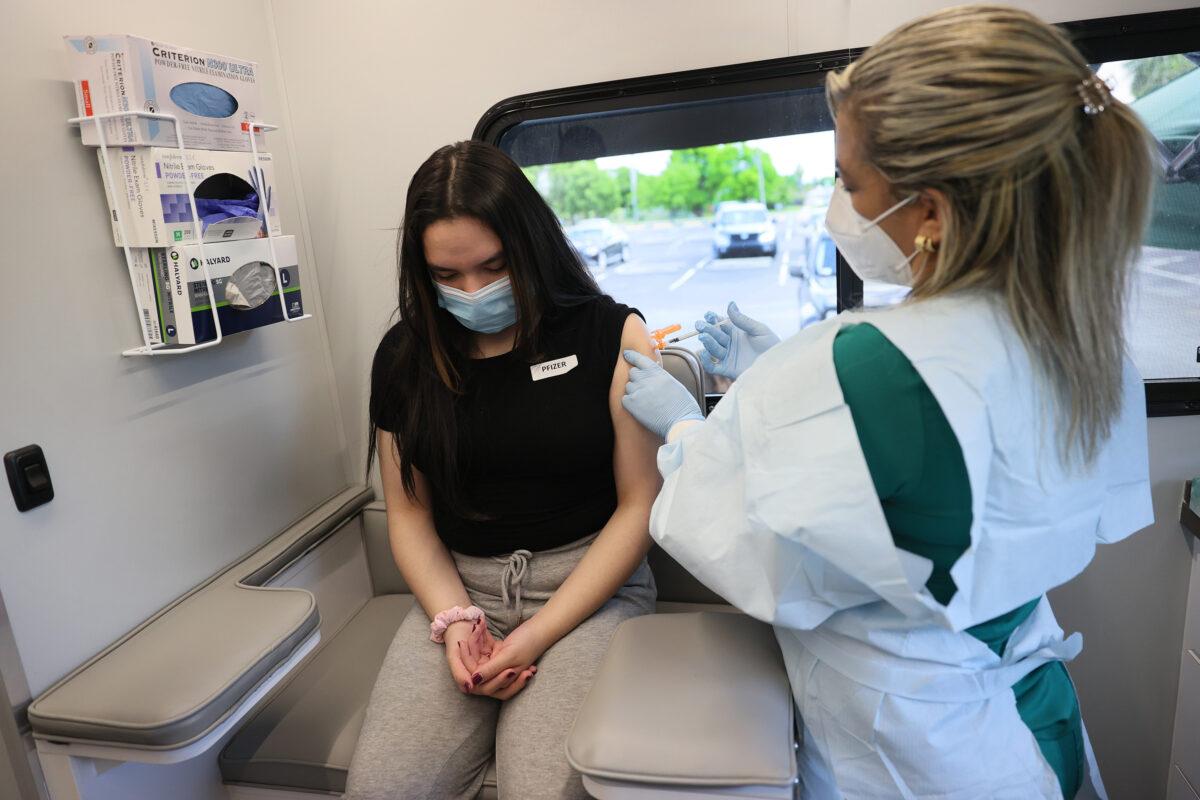 A woman receives a Pfizer-BioNTech COVID-19 vaccine at the UHealth's pediatric mobile clinic on May 17, 2021, in Miami, Florida. (Joe Raedle/Getty Images)