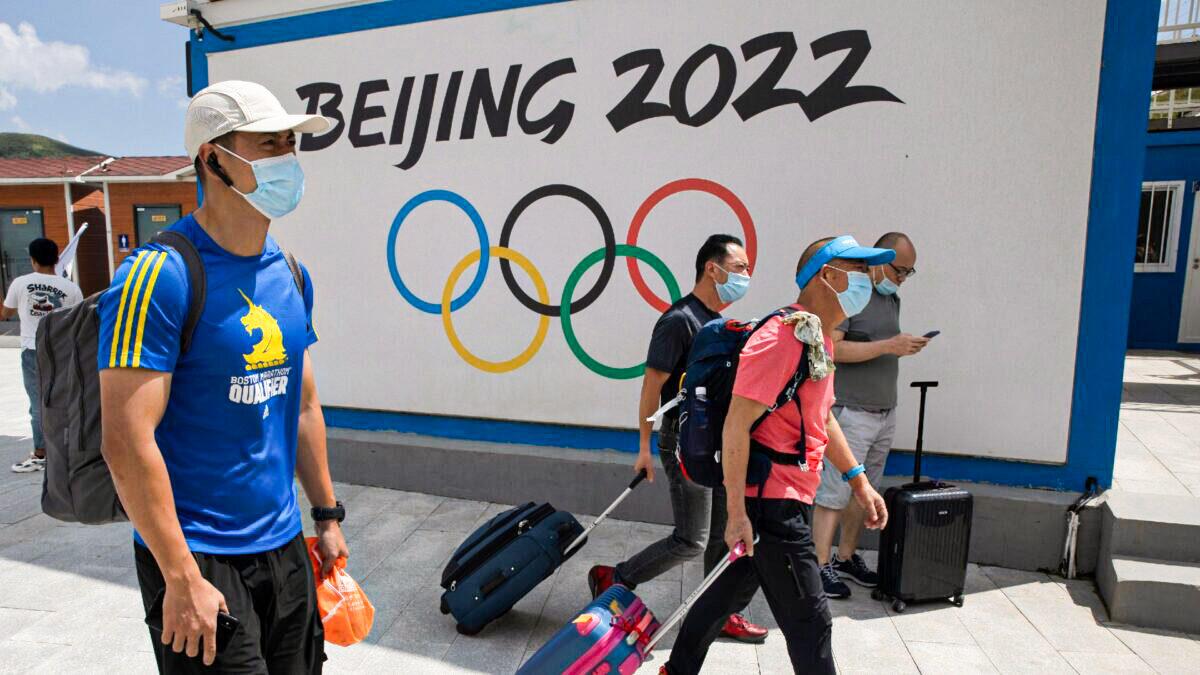 Visitors to Chongli, one of the venues for the Beijing 2022 Winter Olympics, pass the Olympic logo in Chongli in Hebei Province, China, on Aug. 13, 2020. (Ng Han Guan/AP Photo)