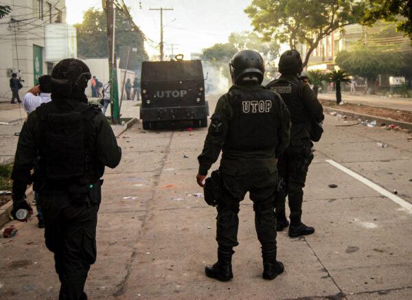 Police use tear gas to disperse rioters in Santa Cruz on Dec. 13, 2021. (Cesar Calani/The Epoch Times)