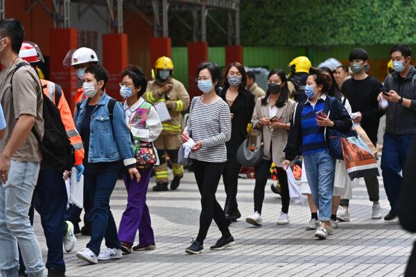 People walk out from the World Trade Center in Hong Kong, on Dec. 15, 2021. (Sung Pi-lung/The Epoch Times)