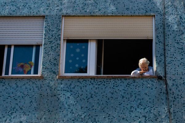 An elderly woman looks on from her window in Barcelona, Spain, on April 26, 2020. (David Ramos/Getty Images)