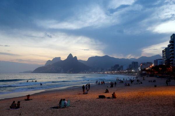 People gather on Ipanema beach at sunset on May 29, 2021 in Rio de Janeiro, Brazil. (Mario Tama/Getty Images)