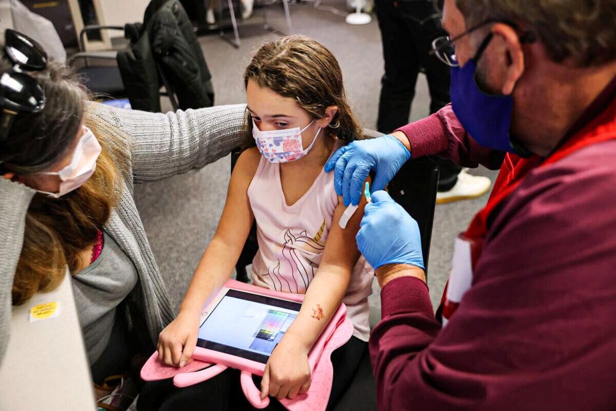 A child receives the Pfizer-BioNTech COVID-19 vaccination at the Fairfax County Government Center in Annandale, Va., on Nov. 4, 2021. (Chip Somodevilla/Getty Images)