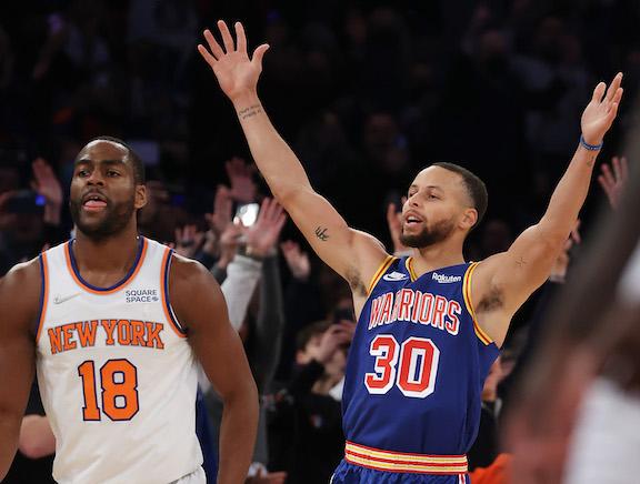 Stephen Curry #30 of the Golden State Warriors celebrates after making a three-point basket to break Ray Allen’s record for the most all-time as Alec Burks #18 of the New York Knicks looks on during their game at Madison Square Garden in New York City, on Dec. 14, 2021. (Al Bello/Getty Images)