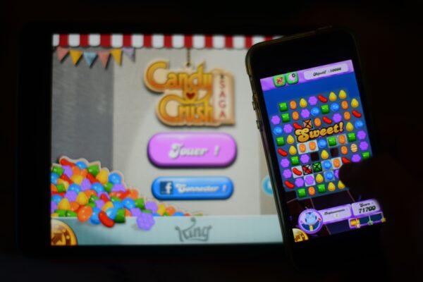 A man plays Candy Crush Saga on his iPhone in Rome on Jan. 25, 2014. (GABRIEL BOUYS/AFP via Getty Images)