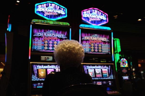 An elderly woman plays slot machines in a casino in Atlantic City, N.J., in a file photo. (John Moore/Getty Images)