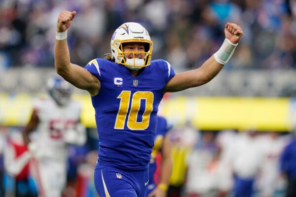 Los Angeles Chargers quarterback Justin Herbert celebrates after throwing a pass to wide receiver Jalen Guyton during the first half of an NFL football game in Inglewood, Calif., on Dec. 12, 2021. (Gregory Bull/AP Photo)