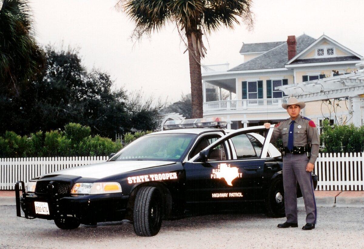 Le Roy Torres pictured with his state trooper car. (Courtesy Le Roy Torres)
