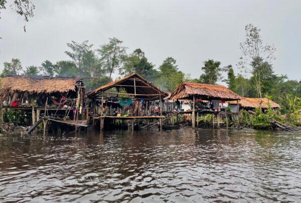 Open-air huts constructed along rivers give limited protection against the rain and mosquitoes carrying diseases such as malaria. (Richard Bhainie for The Epoch Times)