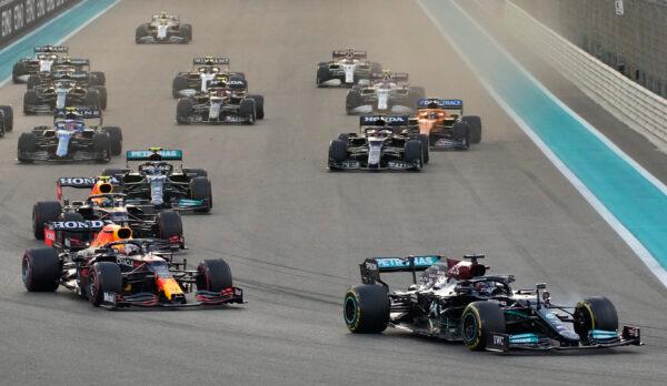 Mercedes driver Lewis Hamilton of Britain in leads Red Bull driver Max Verstappen of the Netherlands at the start of the Formula One Abu Dhabi Grand Prix in Abu Dhabi, United Arab Emirates, on Dec. 12, 2021. (Hassan Ammar/AP Photo)