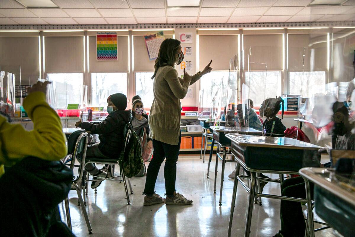 A third-grade teacher talks with students about their pandemic-related fears on the first day of in-person learning for five days per week at Stark Elementary School in Stamford, Conn., on March 10, 2021. (John Moore/Getty Images)
