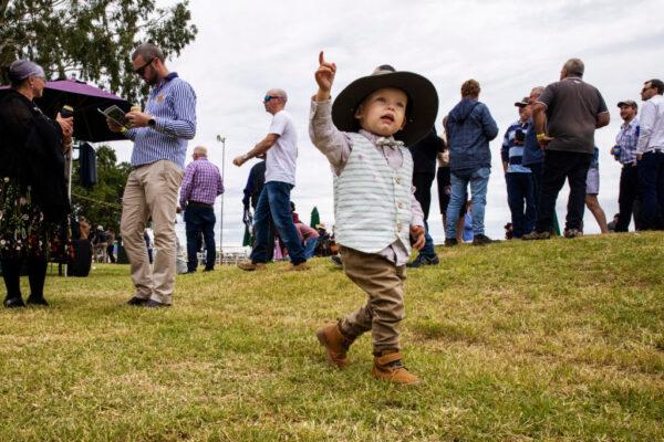 A young boy is seen pointing during the Cobar Races at Cobar Miners' Race Club in Cobar, Australia on May 8, 2021. (Jenny Evans/Getty Images)