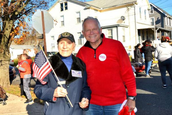 Parade Grand Marshal Ray Firmani (L) and Congressional candidate Lee Murphy share their happiness at the Christmas parade, in Elsmere, Del., on Dec. 12, 2021. (Frank Liang/The Epoch Times)